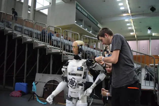 Técnico trabajando en un robot humanoide en una exposición de tecnología en Guimarães, Portugal. (Foto: Pexels)